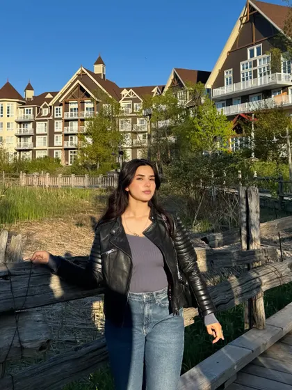 Posing at Blue Mountain resort during the golden hour, wearing a leather jacket and jeans.