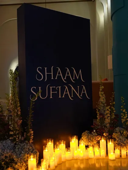 The entrance signage for 'Shaam Sufiana,' surrounded by a sea of candles. This simple yet powerful detail set the tone for an evening steeped in mood and meaning.