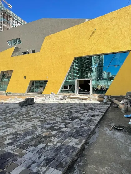 Paving work underway in front of the nearly complete brigade utopia clubhouse.