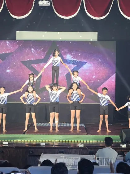 This star formation is a crowd favorite, showcasing how our gymnasts work together. It's a perfect example of the group activities we practice to build unity and create a spectacular show.