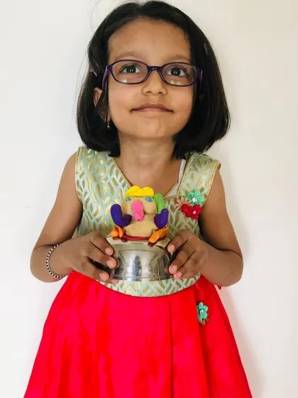 This student's colorful Ganesha, held in a small cup, is a wonderful example of her creativity and resourcefulness.