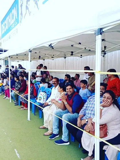 A duplicate shot of the parents and audience watching the event.