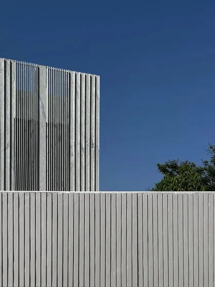 The clean lines of a stone facade under construction. We often use natural materials like stone to create buildings that feel grounded and connected to their environment.