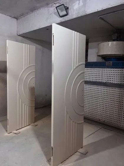 Custom doors being prepared in our paint booth. The concentric circle design adds a modern, graphic element, and our in-house finishing ensures a flawless result.