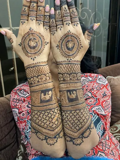 This full-arm design features elephant motifs in two places, on the arm and in the central mandala on the palm.
