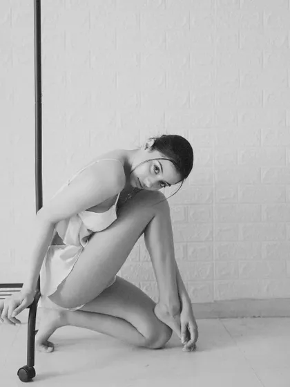 A close, intimate portrait in black and white, where the model's gaze and the simple pose create a powerful connection.