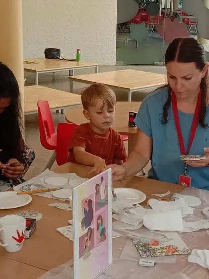 A mother and son working together on a decoupage project.