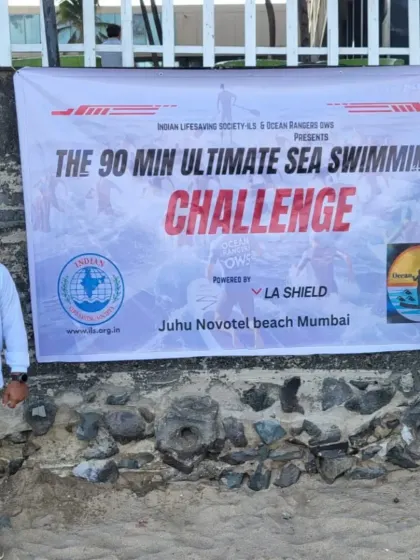 The official banner for "The 90 Min Ultimate Sea Swimming Challenge" presented by the Indian Lifesaving Society and Ocean Rangers OWS at Juhu Novotel beach.
