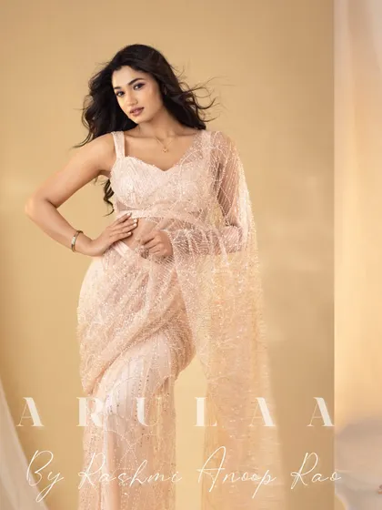 The full look of the peach sequin saree. The simple, modern blouse allows the shimmering fabric of the saree to be the main attraction.