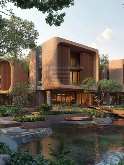 This eco-friendly design in Kanakapura features three uniquely shaped structures made from terracotta clay. The buildings are seamlessly integrated with the landscape, featuring serene water features and interconnected courtyards to promote a sustainable lifestyle.