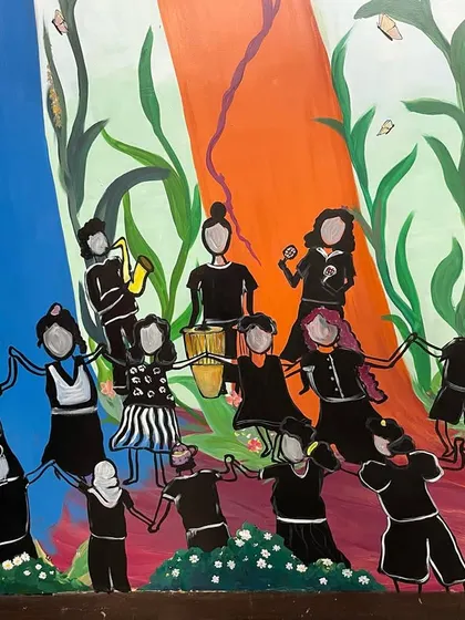 This mural holds a special place in my heart as it was painted for The Gender Lab, the organization where my journey as a facilitator began. It represents the ever-evolving, fluid nature of the organization, depicted as a colorful jungle where a community of people are dancing and celebrating their journeys together.