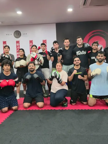 The full class poses after an amazing session with one of our expert coaches. The mix of beginners and experienced students shows our welcoming environment.