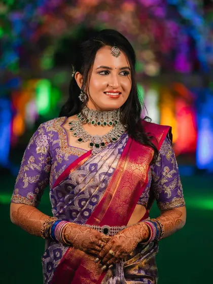 A close-up of the same client, showing the intricate details of the necklace and her beautiful makeup.