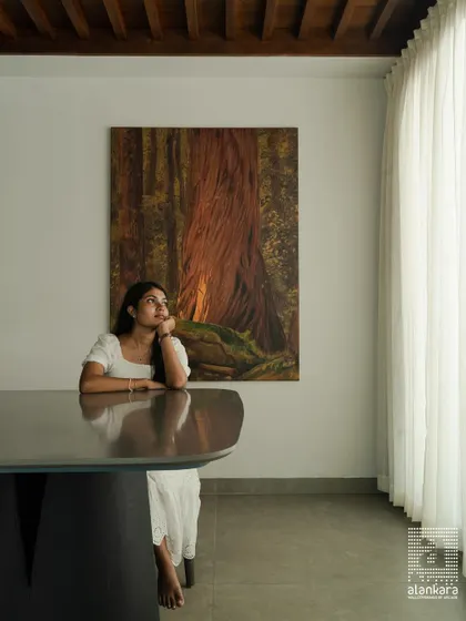 A moment of reflection at a dining table I designed. This piece features a unique, sculptural base and a smooth, expansive top, showcasing my ability to create furniture that is both functional and a work of art.