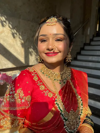 A radiant smile captured in the golden hour light. The makeup is designed to look flawless both in person and on camera.
