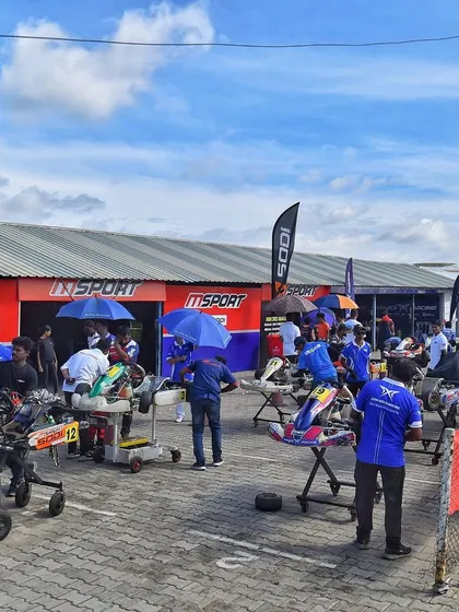 A view of the bustling pit area, where teams prepare their karts for the upcoming sessions.