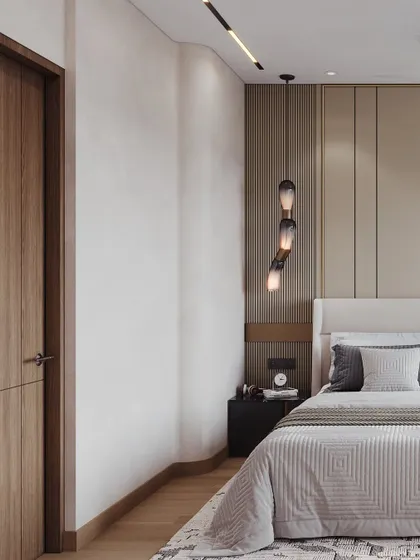 This angle shows the bedside detail, with a cascading pendant light and textured wall panels adding subtle interest to the minimalist design.