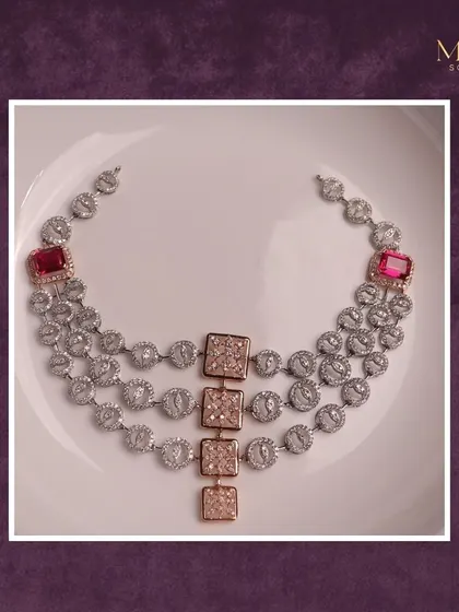 A modern take on a classic design. This three-layered diamond necklace is accented with square-cut rubies and a unique rose gold centerpiece. It's a true masterpiece of elegance.