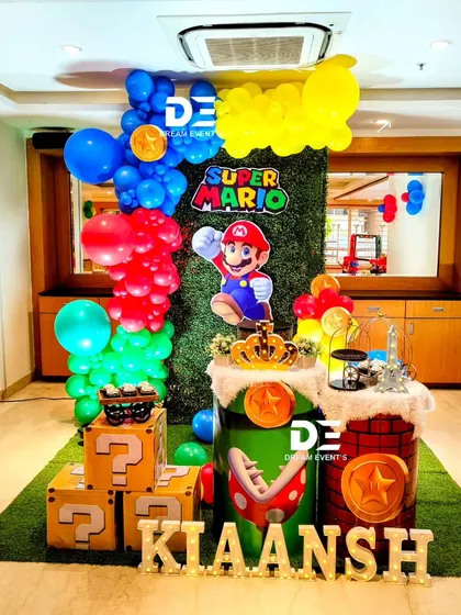 It's-a-me, Mario! A Super Mario themed party for Kiaansh, complete with question mark blocks, piranha plants, and a green turf floor to recreate the iconic video game world.