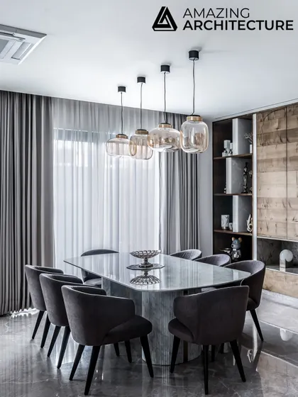 Featured in Amazing Architecture, the dining room in our Silhouette project uses a mix of warm wood, cool marble, and soft grey upholstery. The design creates an elegant and light-filled space that truly brings the family together.