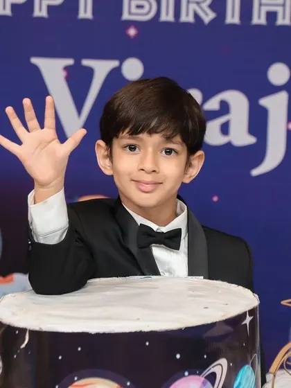 A sophisticated outer space theme for a 5th birthday. The birthday boy looks dapper in his tuxedo, ready to celebrate among planets and stars. This theme shows our versatility in creating parties for older kids as well.