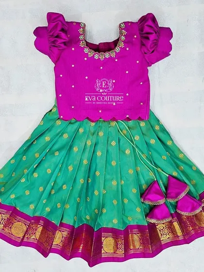 A lovely pattu lehenga in magenta and teal for babies. This ready-to-dispatch outfit is available in newborn and 6-9 month sizes, with margins to fit up to 2 years.