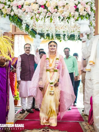 The bride's grand entrance under a phoolon ki chadar, a beautiful and traditional moment.