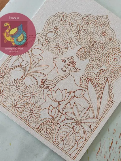 The detailed brown outline of the showstopper Pichwai Cow painting. The intricate floral background and the serene cow are all carefully drawn, ready for color.