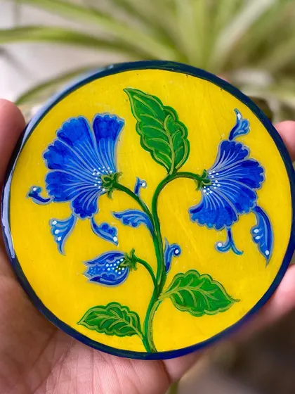 This Jaipur ceramic-inspired floral design is coated in art resin, which makes the colors look absolutely alive and gives the piece a glossy, protective finish.