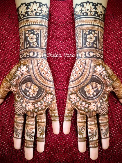 A symmetrical design with elephant motifs in the center, surrounded by floral and geometric patterns.