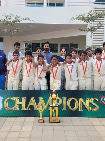 Our victorious U13 team posing with the champions banner after winning the DPS Bangalore North inter-school tournament.