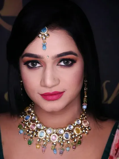 A sharp winged liner and a bold lip for this creative shoot. The makeup was designed to complement the unique multi-colored necklace and modern saree.