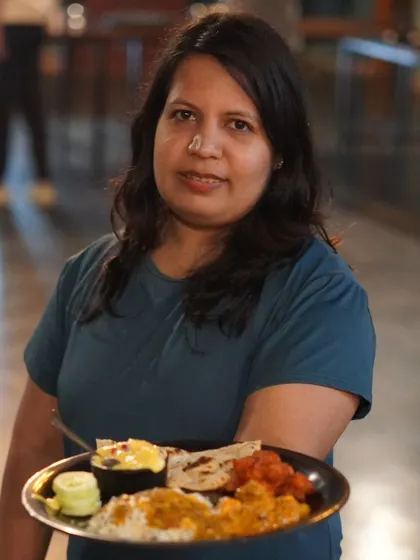 A happy guest showing off her plate from our unlimited buffet. We pride ourselves on serving delicious and satisfying meals.