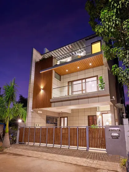 The recently completed villa in Odion Woods of the East, photographed at dusk. Built on a compact 30x60 plot, the floors are recessed at each level to reduce the building's perceived scale from the street.