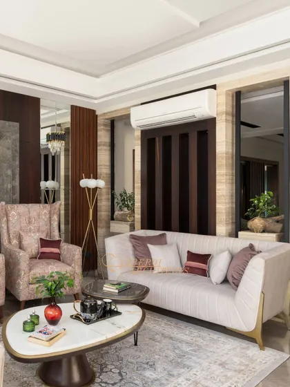The combination of a floor lamp, natural light, and reflective surfaces makes this living room feel bright and welcoming.