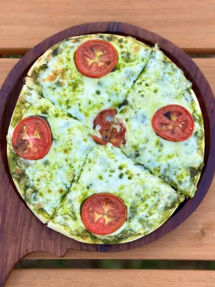 Our Basil Pesto & Tomato Pizza is fresh, light, and full of flavor. A popular choice for our human visitors.