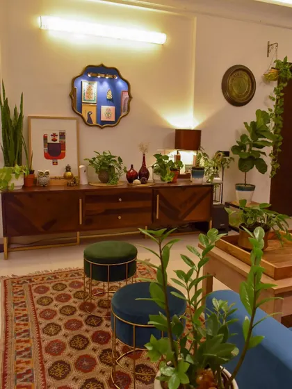 This view showcases the console table, which also serves as a plant stand. Using furniture to display plants is a great way to integrate them into your decor.