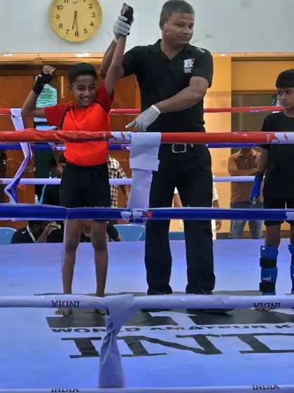 A young champion gets his hand raised in the ring at a K-1 kickboxing event. We start them young and teach them how to win.