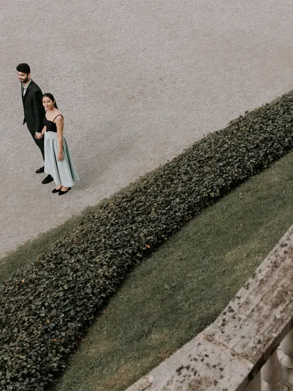 An overhead shot of the couple in the gardens of Lake Como, using the manicured hedges to create leading lines and a strong composition.