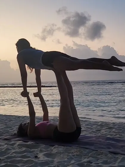A moment of sunset acro yoga play. Partner yoga builds trust and communication, and it's even more special with a beautiful view.