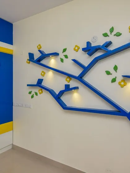 A playful and creative wall decor idea for a kids' room. This custom-built, tree-shaped bookshelf with integrated lights is not just for storage but also serves as a beautiful and imaginative feature wall.