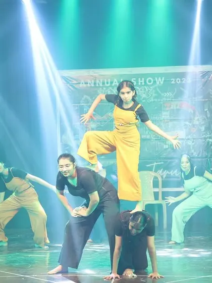 A lift formation in the contemporary act, highlighting the trust and connection between the dancers.