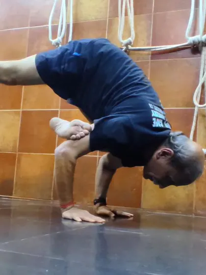 Moving into Parsva Bakasana (Side Crow Pose), an arm balance that builds strength in the arms and wrists while toning the abdominal organs through a deep twist.