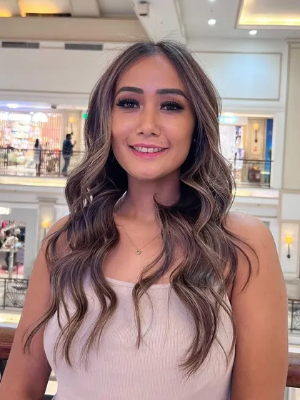 A happy client showing off her new balayage. The mix of tones is perfect for a dimensional, sun-kissed look that is always in style.