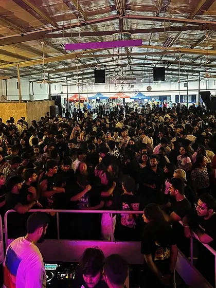 Looking out over a completely packed warehouse-style venue for a college event. I can adapt my setup and sound for any type of space, from open fields to indoor halls.