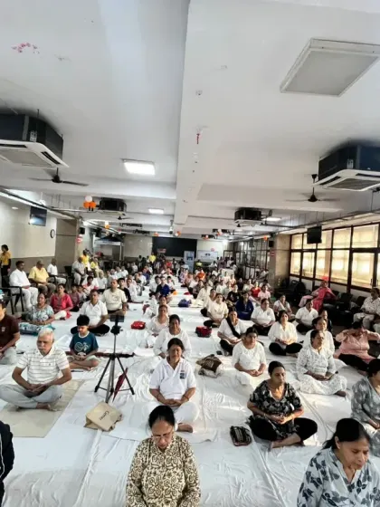 A hall full of participants meditating together during our International Yoga Day event. The collective silence and focus created a powerful, peaceful atmosphere.