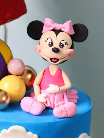 A sweet Minnie Mouse figurine in her classic pink dress. This topper is perfect for a first birthday or any Disney fan's celebration.