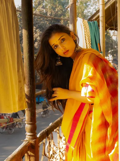 Looking out from a balcony, with the busy street below blurred out. This creates a sense of being in a private oasis above the city.