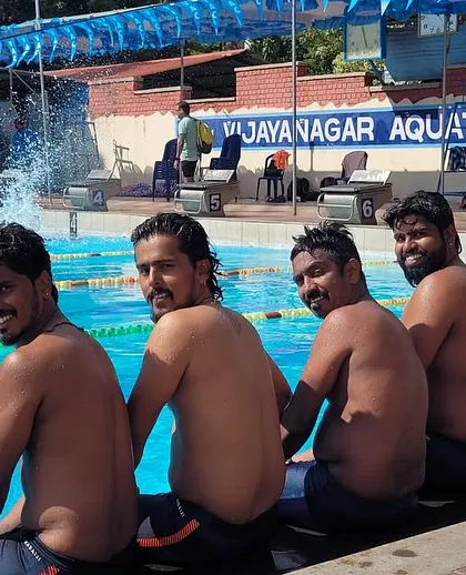 Our masters team sharing a relaxed moment by the pool after competing at the Karnataka State Championship.