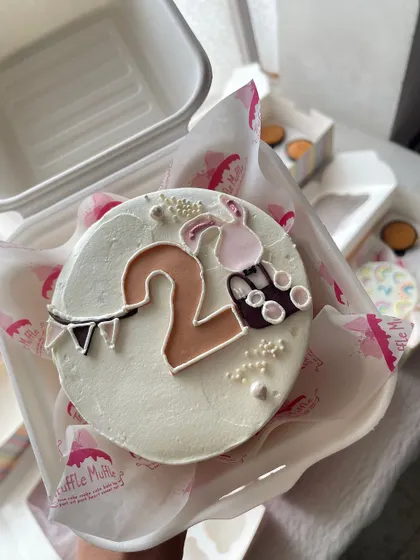 A sweet bento cake for a second birthday. The design features the number two and a little bunny, perfect for a toddler's celebration.
